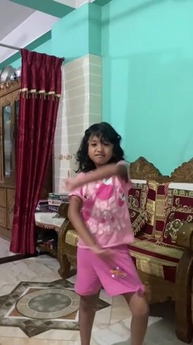 A Dhaka morning at home: a cat, a kid, and the city outside