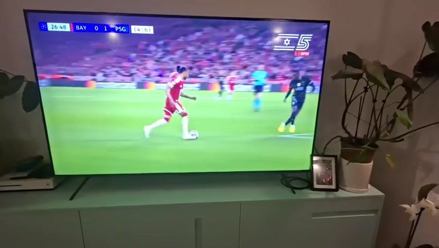 Casual evening moments captured in Givatayim home during soccer match