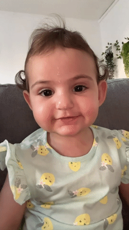 Baby plays on couch in Strasbourg home
