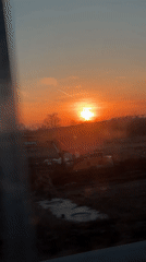Low sun captured over construction site and roadway in Russia