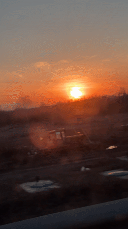 Low sun captured over construction site and roadway in Russia