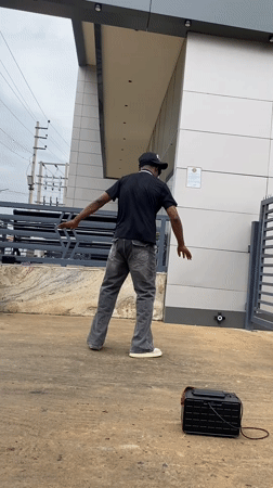 Man performs street dance outside building in Bukuru