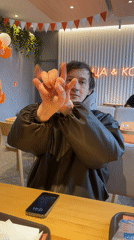 Man performs magic trick at cafe table in Murino