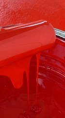 Person handles red paint equipment in Tinaquillo, Venezuela