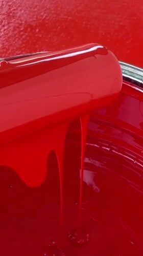 Person handles red paint equipment in Tinaquillo, Venezuela