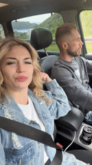 Woman films selfie video from car passenger seat in Montenegro