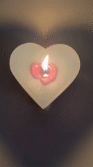 Heart-shaped candle burns, casts shadow in Sofia