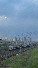 Moscow commuter train documented at station during evening rush