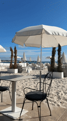 Person spotted at Cannes beachfront amid white umbrellas
