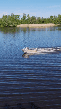 Motorboat crosses calm waters near Chaika, Russia