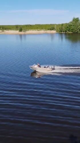Motorboat crosses calm waters near Chaika, Russia