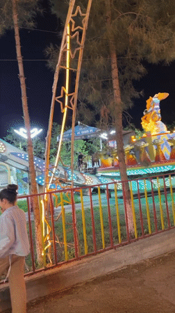 Nighttime amusement park activity captured in Khujand, Tajikistan