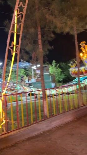 Nighttime amusement park activity captured in Khujand, Tajikistan