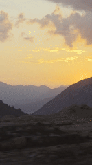 Witness captures mountain sunrise, full moon, modern architecture sequence