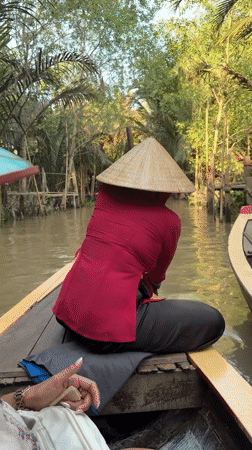 Tourist boat tour navigates Mekong Delta canals in Thoi Son
