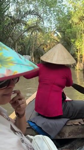 Tourist boat tour navigates Mekong Delta canals in Thoi Son