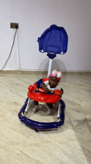 Baby in colorful walker, all smiles in Gura Top