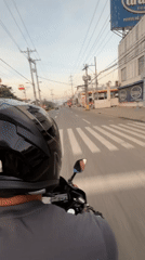 Motorcycle rider navigates evening traffic in Davao City