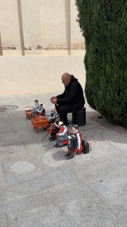 Street performer with marionettes, inflatable Pikachu entertain in Seville