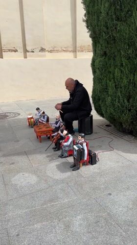 Street performer with marionettes, inflatable Pikachu entertain in Seville