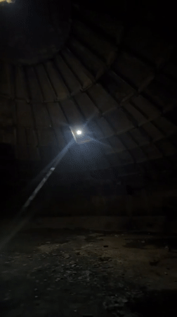Tourist explores historic stone dome interior in Tbilisi