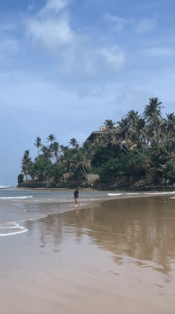 Quiet morning on a Sri Lankan beach and its nearby village