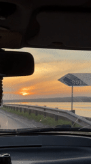 Driver captures sunset view near water in Chaikovsky, Russia