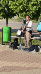 Street musician performs acoustic set near Izhevsk waterfront park