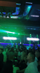 Live performance draws dancing crowd at nightclub venue