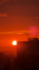 Kazan sunset blazes orange behind construction cranes