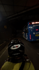 Motorcyclist follows Transjakarta bus through Central Jakarta tunnel