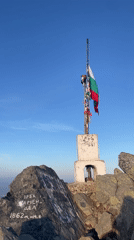 Bulgarian flag waves on mountain peak in Sofia