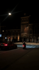 Nighttime Amsterdam street activity documented near Rijksmuseum exhibition