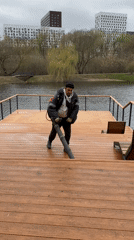 Man clears riverside deck with leaf blower in Moscow