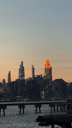 Empire State Building glows red at sunset in NYC