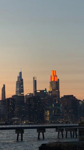 Empire State Building glows red at sunset in NYC