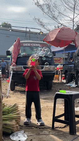 Daily life unfolds at Ubud markets as vendors, tourists mingle