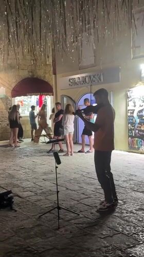 Budva old town: street violin, coastal scenes, summer evening