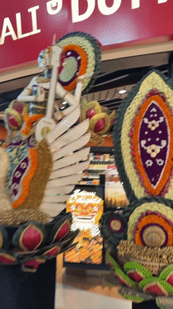 Bali airport duty-free zone packed with ornate Balinese cultural displays