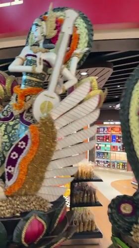 Bali airport duty-free zone packed with ornate Balinese cultural displays