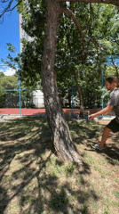 Man performs athletic move around tree in Podgorica