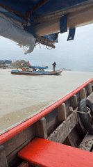 Longtail boat moving through Pak Nam waterways
