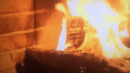 Man watches virtual fireplace on TV in Nigerian home