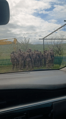 Military personnel disembark from trucks in Rustavi, Georgia