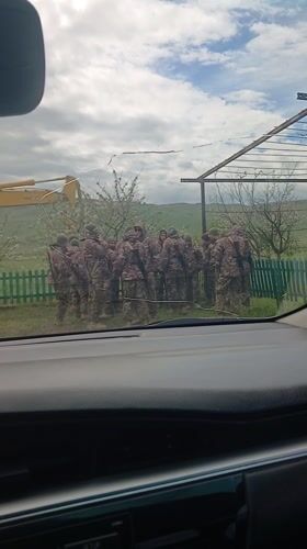 Military personnel disembark from trucks in Rustavi, Georgia