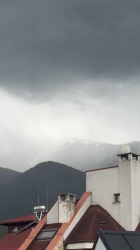 Cloudy conditions blanket mountains in Bansko, Bulgaria