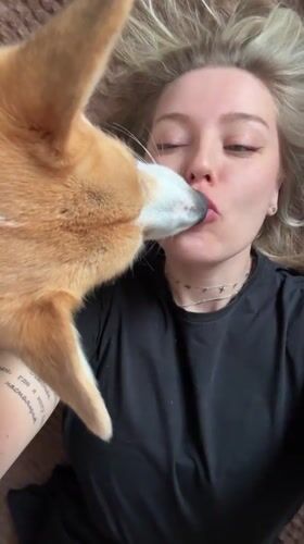 Woman and corgi share playful moment in Borzya