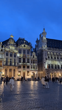 Evening pedestrian activity captured in historic Brussels square