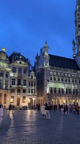Evening pedestrian activity captured in historic Brussels square