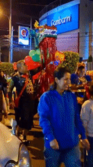 Costumed nighttime parade with dragon, clown figures in Arequipa